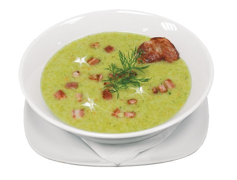 Een soepkom met groene soep er in en vlees